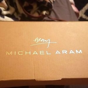 Two twisted gold candle holders